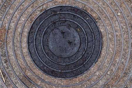 old, rusty manhole contaminated dustの写真素材