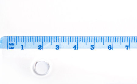 Ruler over white background with details and numbers.の写真素材