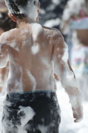 Foam party picture with children. Happy scene.の写真素材