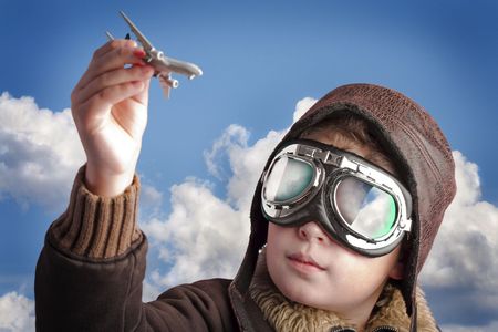 Boy dressed up in pilot´s outfit, jacket, hat and glasses.の写真素材