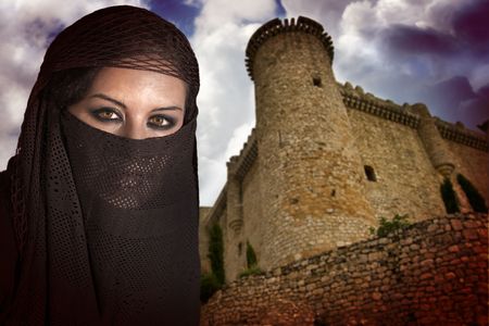 woman dressed in Arab costume, castle in the backgroundの写真素材