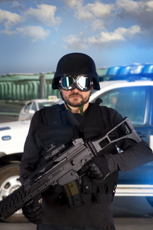 Armed man in protective cask with machine gun. Police