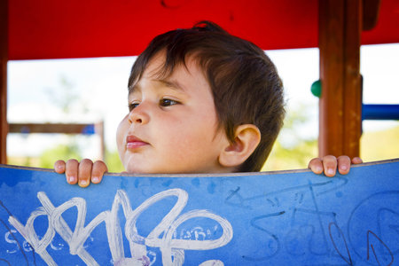 little boy playing hide and seek in the parkの写真素材