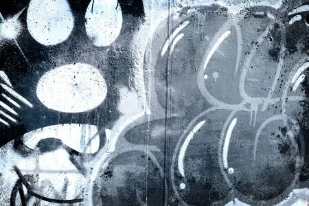 Graffiti over old dirty wall, urban hip hop background Gray texture painted with bright colorful