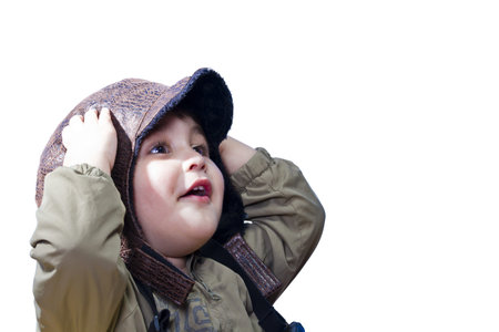 A baby boy surprised and fascinated wearing old pilot's uniform