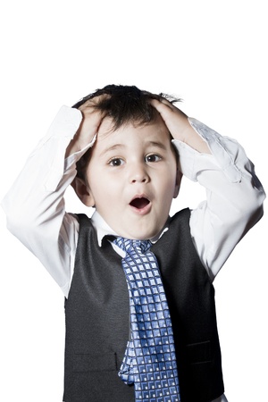Child dressed like businessman with hands on his head surprisedの写真素材