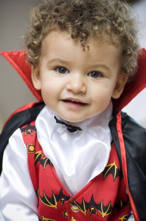 beautiful blond boy dressed with vampire curlsの写真素材