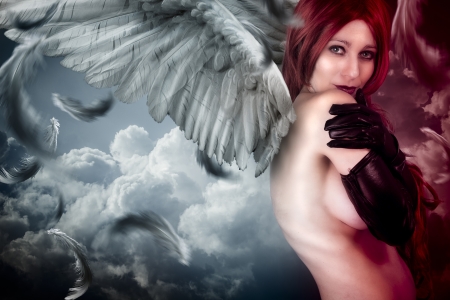 Female angel posing over a cloudy skyの写真素材
