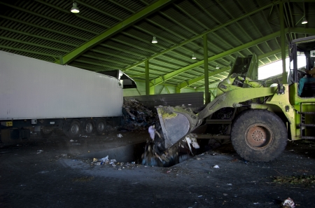 Recycle, overview of refuse collection with green bulldozerのeditorial素材