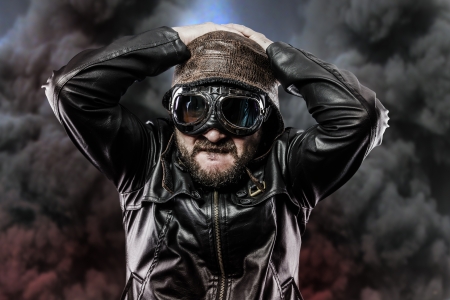 pilot with glasses and vintage hat over background explosionの写真素材