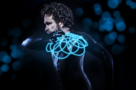 fantasy and science fiction, black latex man with blue neon diskの写真素材