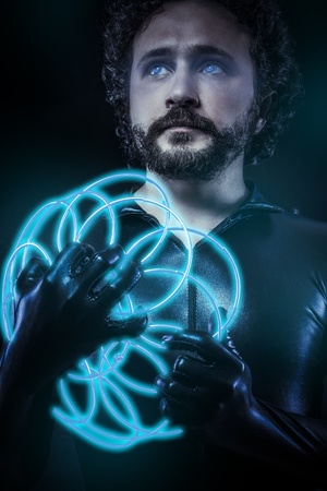 fantasy and science fiction, futuristic soldier dressed in black latex with blue neon gun, blue eyesの写真素材