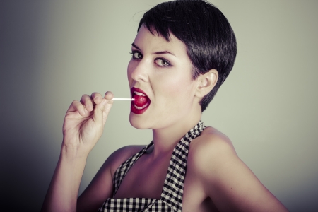 Vintage woman eating a lolly popの写真素材