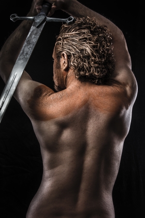 Warrior with sword, Dream, Anger, Dreaming, man covered in mud, naked, in profile, dirty skinの写真素材
