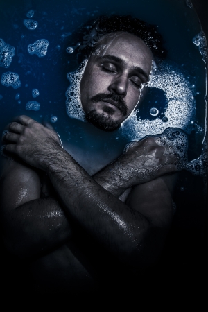 Man on water, melancholy, sadness and depression conceptの写真素材