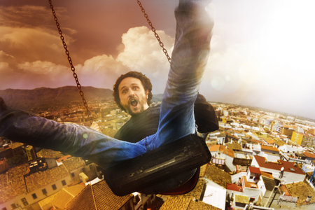 concept crazy, mad and happy man climbed a swing
