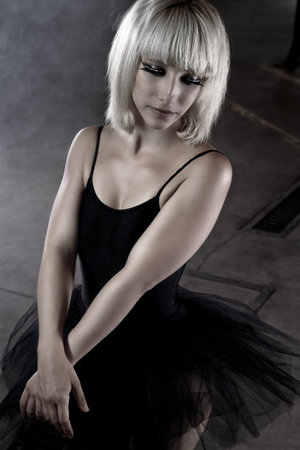 Ballet dancer, sexy young in an industry area, sensual blonde woman with tutuの写真素材
