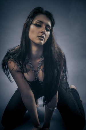 Dark fetish, beautiful brunette young with silver chains