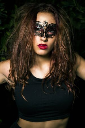 Masked lady. Beautiful Teenage Model Dressed in Fashionable Short Dress. Beauty Romantic Girl Outdoor.  Toned in warm colors. Fashion Lookの写真素材