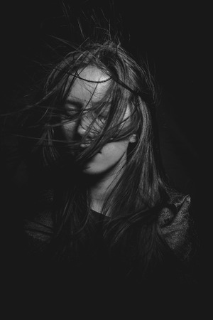 Portrait of young female beauty with long dark hair in black and whiteの写真素材