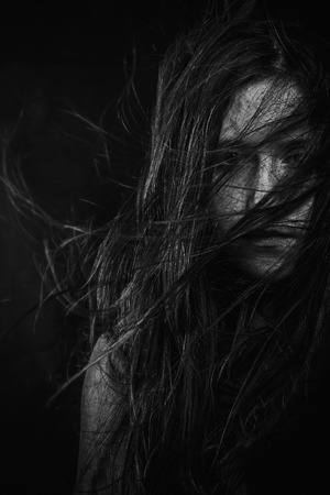 Scary, Portrait of young female beauty with long dark hair in black and whiteの写真素材