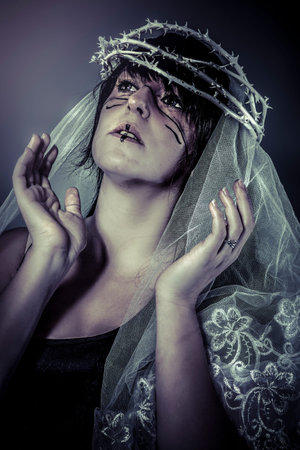 faith concept, woman dressed in white veil and crown of thorns, virgin