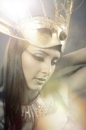 Fantasy concept, woman with fashioned golden maskの写真素材