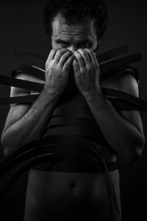 Man with black shapes, studio portraitの写真素材