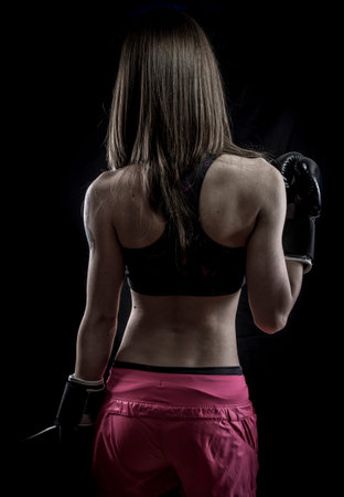 Healthy, strong woman athlete with boxing gloves