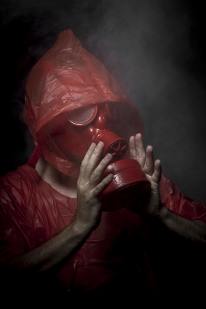 Hazard, A man in a gas mask over  the smoke. black background and red colorsの写真素材