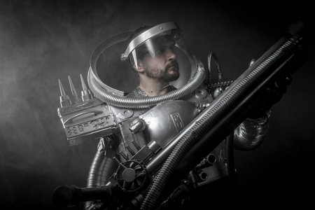 Cosmonaut, Astronaut on a black background with huge weapon.の写真素材
