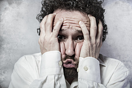 Fear, man in white shirt with funny expressionsの写真素材