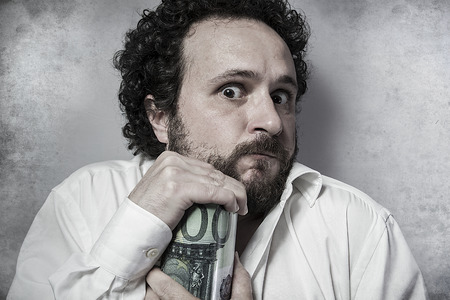 Save, stingy businessman, saving money, man in white shirt with funny expressionsの写真素材
