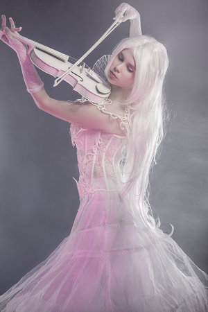 Fantasy concept, sensual young woman with vintage white violinの写真素材