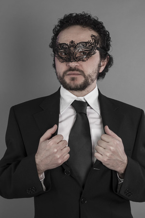 Sexy and mysterious businessman with maskの写真素材