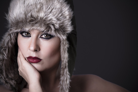 Woman frustrated with fur hat, winter conceptの写真素材