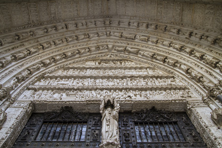 side entrance of the Cathedral of Toledo, arc with religious reliefsの写真素材