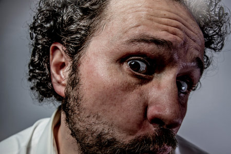 Fear, man with intense expression, white shirtの写真素材