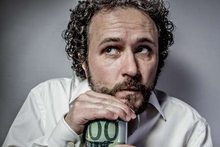 Saver, man with intense expression, white shirtの写真素材