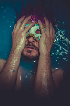 Sad man immersed in bluewater, concept of depressionの写真素材