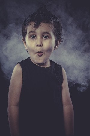 Surprise, boy with funny hair crest and appearance of rockerの写真素材