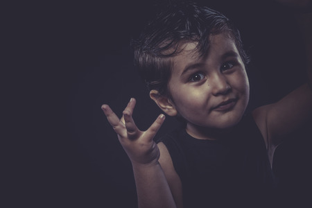 little boy with slicked-back hair, funny and expressiveの写真素材
