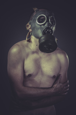 Nude man with gas mask, pollution conceptの写真素材