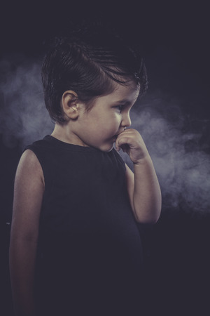 thinking, boy with slicked-back hair, funny and expressiveの写真素材