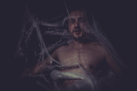 Horror, Man trapped in a spider webの写真素材