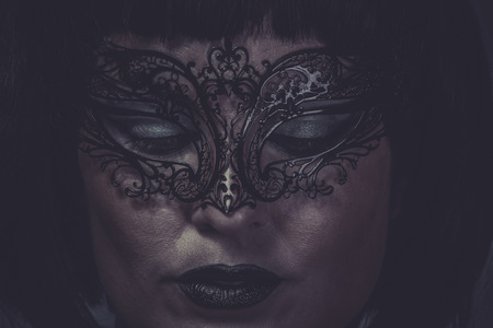 Sad, portrait of woman with black mask thread Venetianの写真素材