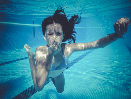 teenager diving into a poolの写真素材