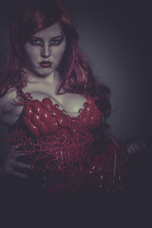 Valkyrie war woman dressed in red armor and helmet dragon scalesの写真素材