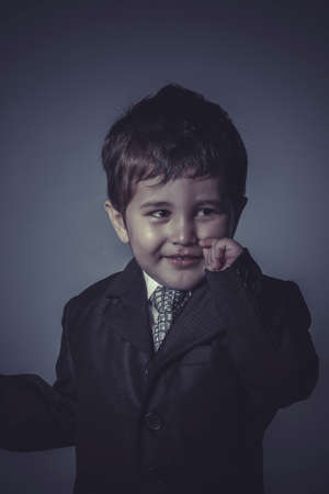 office little business boy over grey backgroundの写真素材