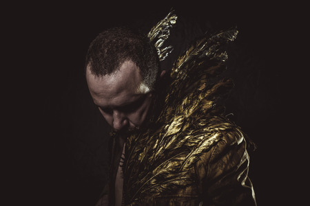 Fashion, man beard and suit made with golden wingsの写真素材